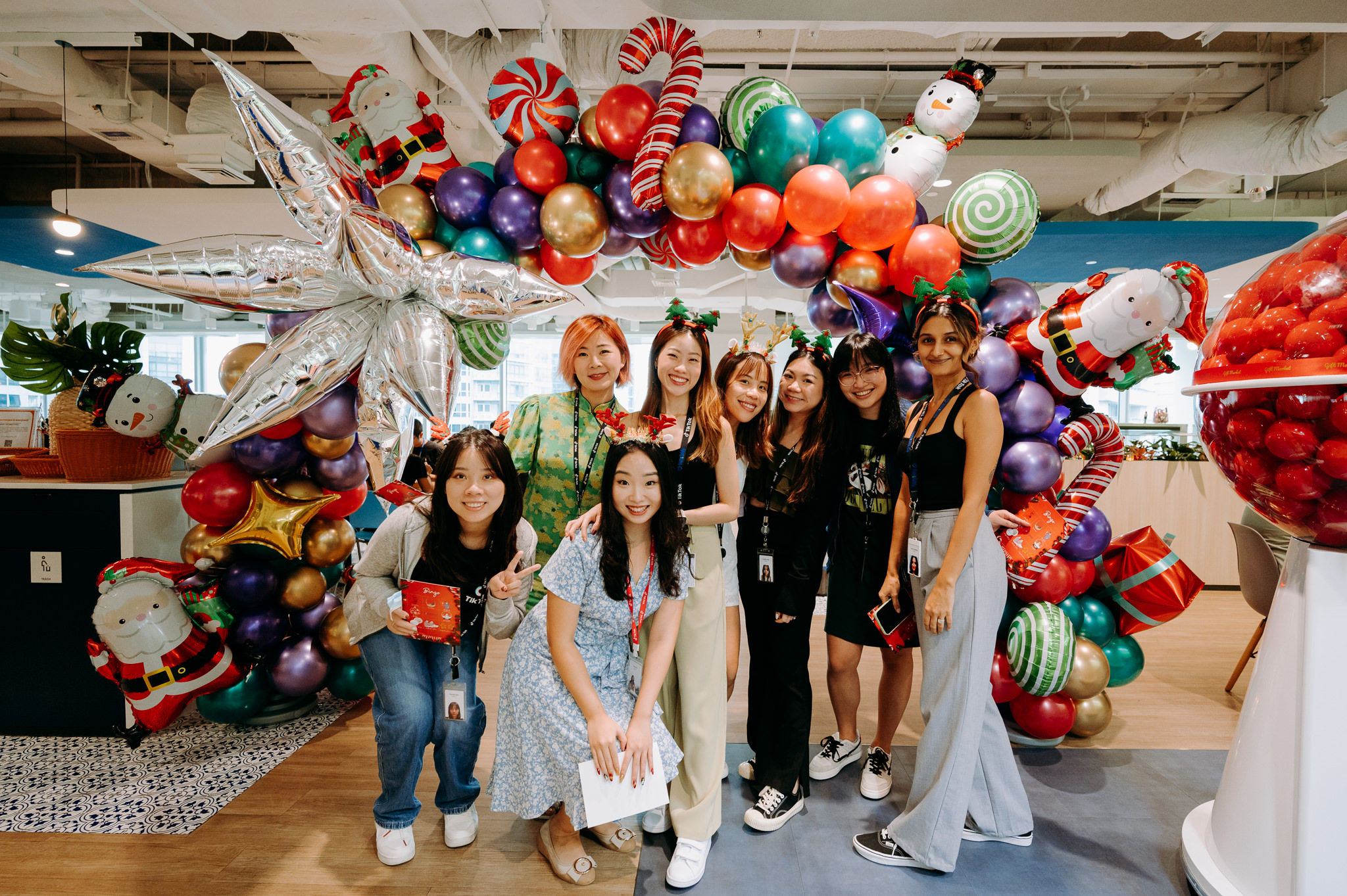 ByteDance staffs posing for photo in the office, in front of a balloon arch=